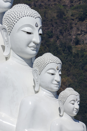 Close up the face of white buddha with mountain background in Wat Pha Sorn Kaew, Ban Khao Kho, Phetchabun. The landmark travel of thailand.の写真素材