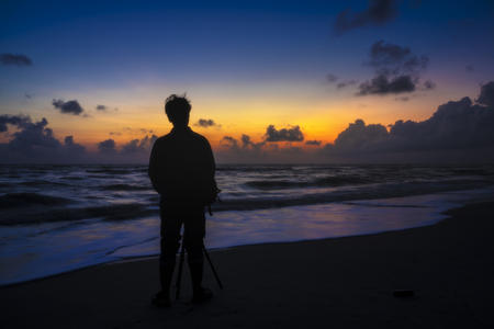 Long exposure on the beach with Silhuette men before sunrise.の写真素材