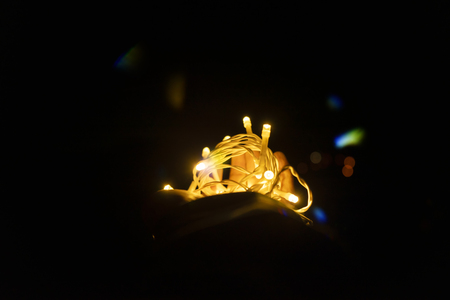 LED Light on hand in a dark background with bokeh light.の写真素材