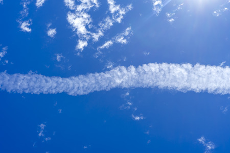 Blue sky background with white clouds.