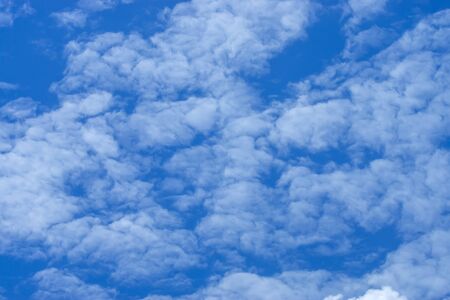 Blue sky background with white clouds.