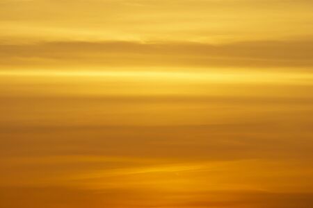 Orange sky with soft cloud and light in sunset sky background.の写真素材