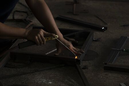 Welders Connecting the steel industry in the dark background.