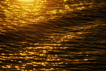 Defocus Water surface images reflect the sunlight at the lake in golden time