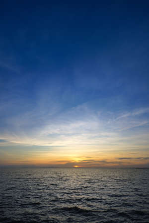 Sunset sky at the lake with clouds on the sky background.の写真素材
