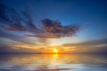 Sunset sky at the lake with clouds on the sky background.の写真素材