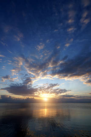 Vertical Seascape, sunset sky with clouds at the lake.の写真素材