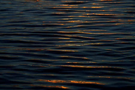 Close up water surface of the wave with soft sunlight.の写真素材