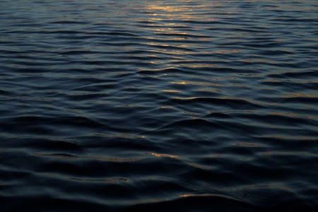 Close up water surface of the wave with soft sunlight.の写真素材
