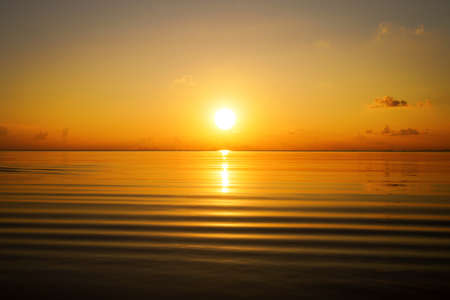 Seascape, Golden hour sky at the lake with soft wave.の写真素材