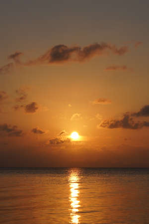 Vertical Seascape, sunset sky at the lake with small clouds on sky.の写真素材