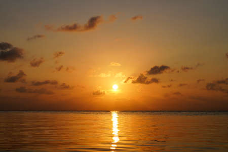 Seascape, sunset sky at the lake with small clouds on sky.の写真素材