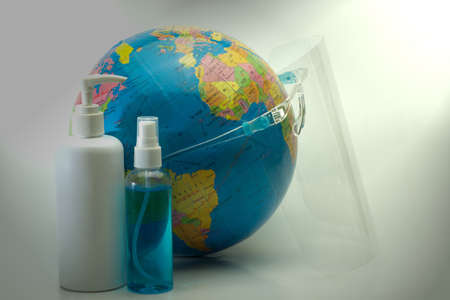 Abstract wearing a face mask SHIELD globe simulates alcohol spray and antiseptic to prevent the...