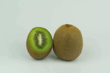 The fruits of the kiwi fruit are full and split in half on a white background.の写真素材