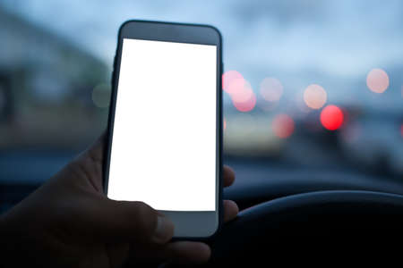 The dangers of using a cell phone while driving at night, select focus.の写真素材