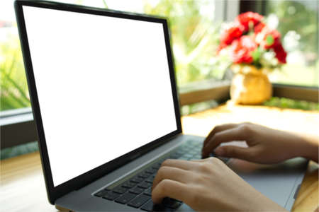 Teenage woman hand using Tablet PC with white screen separate copy space Selective focus.