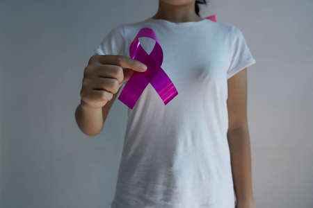 A woman with a pink ribbon on breast cancer awareness Concept of health care and medicine.の写真素材