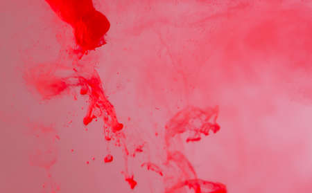Science and art experiment color dripping into red template bright red background image concept.