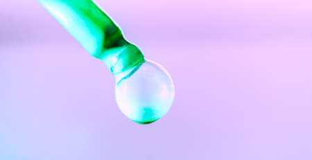 Color drop tube science and art experiment drop color into green template green concept background.