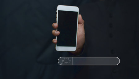 Businessman's hand holding a smartphone with internet search symbol Communication technology concept and online trading via smartphone Selective focus.の写真素材