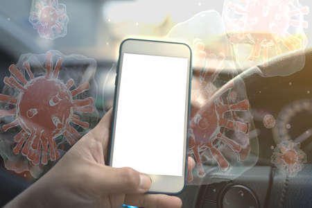A user using a smartphone in the car There are invisible viral particles. The concept of coronavirus outbreak that is everywhere spreads even the use of smartphones in cars to people.の写真素材