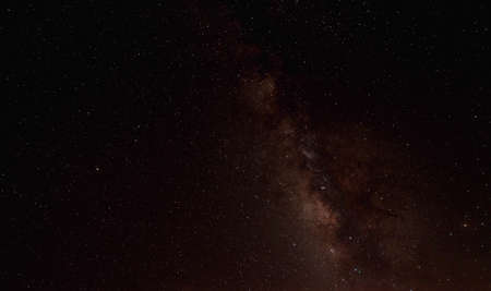 The cosmic landscape was captured in the Milky Way galaxy with stars on the night sky background....