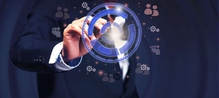 A young businessman uses the darts embroidered onto the tablet abstract to set goals to invest in...