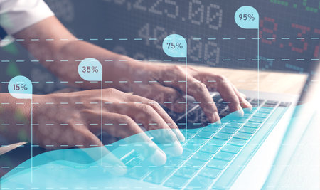 Businessmen use a laptop to view company financial reports and graphics showing financial growth data and figures financial management concepts, planning, strategy, analysis, growth, and profit.の写真素材