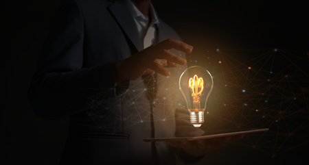 Creative solutions or ideas for designing innovative web banners or hand-drawn landing page templates coming out of tablet screens with colorful abstract geometric bulbs and leading lines.の写真素材