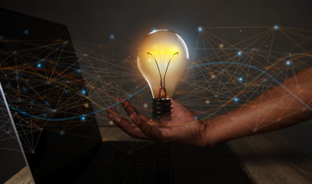Creative solution or idea for web banner design or landing page template for creative agency with hands coming out of the screen with light bulbs and colorful abstract geometric shapes and lead lines.の写真素材