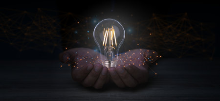 Creative solution or idea for web banner design or landing page template for creative agency with hands coming out of the screen with light bulbs and colorful abstract geometric shapes and lead lines.の写真素材