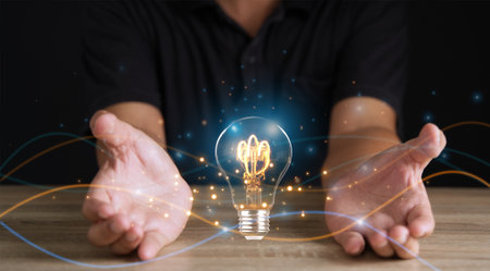 Creative solution or idea for web banner design or landing page template for creative agency with hands coming out of the screen with light bulbs and colorful abstract geometric shapes and lead lines.の写真素材