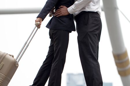 close-up a couple holding hug and kiss with baggage to say goodbye or welcomeの写真素材
