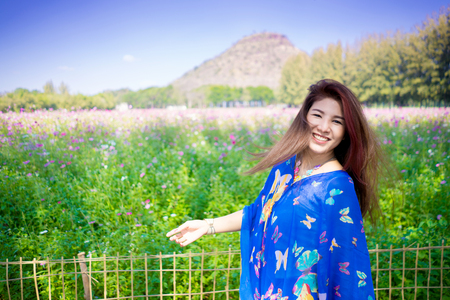 Portrait of attractive girl in cosmos field. Happy smile. Travel summer outdoor holiday freedom concept.
Young Asian woman in colorful flower field spring season with blue sky feeling fresh.
Beautiful female happy in garden, 
Young red-haired joyful lady having fun.の写真素材
