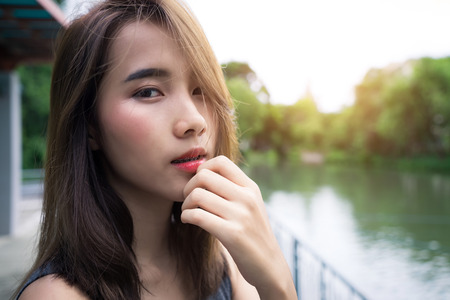 Portrait Happy woman. beauty girl smile face.
Close up lady skin confident cute model healthy care.
Pretty Teenage female relax expressive.
green nature outdoor summer lifestyle.の写真素材