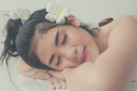 Beautiful Asian woman relaxing with hand massage treatment at beauty spa. Young happy girl in spa salon getting massage. Massage therapy healing medicine and health care concept.の写真素材