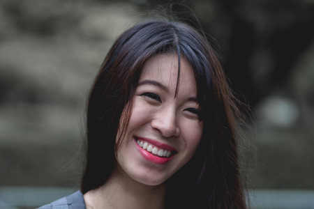 beautiful portrait girl with a stunning smile and cute looksÂ .
close up young beautiful woman face on green background summer nature.Â 
smiling young pretty woman over nature background enjoying in park, sensual fresh happy face, positive emotions.の写真素材