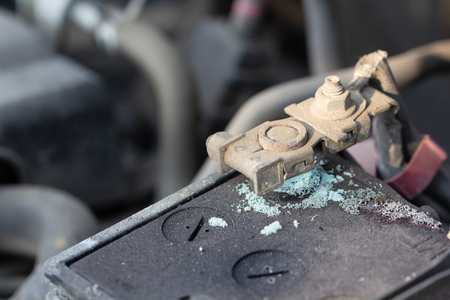 Mechanic checking car Battery terminalÂ in a garageÂ .
Old battery corrosion deteriorate leaking with blue acid powder.
Battery terminals corrode dirty damaged problem.の写真素材