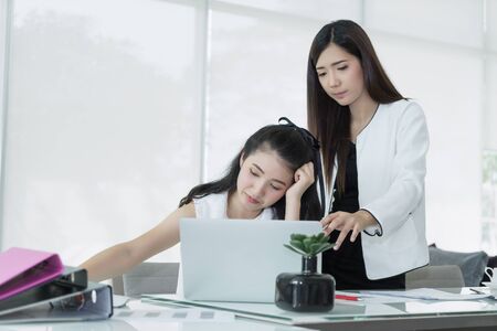 Business women working at office arguing with stressed and confused. boring working.
Two Asian young colleagues working, consult together.
Female boss pointing at laptop computer teaching new employee worker.の写真素材