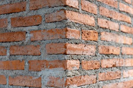 Red corner brick wall architecture design pattern for exterior. Abstract background vuilding angle perspective structure surface texture.の写真素材