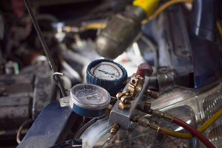 Close up Monitoring tools check car air conditioner system. Vehicle engine maintenanceÂ service, Repair Engine pressure measurement system. Auto mechanic worker fixing air condition in car garage.の写真素材
