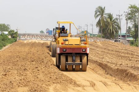 Worker driving road roller repair street road. Road maintenance engineering industrial concept.