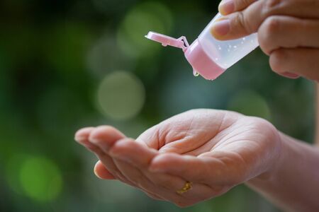 Hand sanitizer bottle gel protect from virus. Female Pouring alcohol gel cleaning virus on sanitizing hands, close up.Woman using antibacterial sanitizer gel wash hands against Novel coronavirus (2019-nCoV).COVID-19 Quarantine, Antiseptic, Hygiene and Healthcare concept.の写真素材