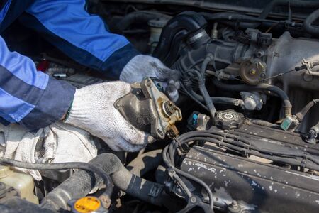 Check engine ignition system and change ignition coil. Car care service.
Replacing ignition coil and spark plugs.
Car mechanic fixing ignition coil on gasoline engine,  four-cylinder internal combustion engine.の写真素材
