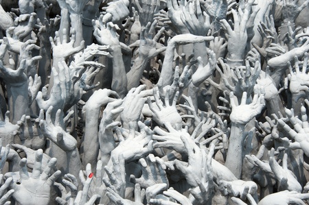 The sculpture represent the hands of evils at White Buddhist temple in Northern Thailandの写真素材