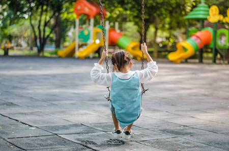 The girl played happily swinging.の写真素材