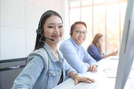 Call Center Service. Photo of customer support or sales agent.  Help line answering and telemarketing. Female caller or receptionist phone operator.Copy space for some text, advertising or slogan.の写真素材
