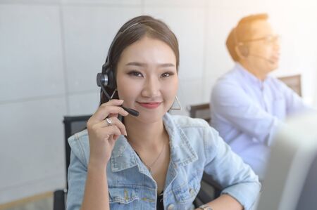 Call Center Service. Photo of customer support or sales agent.  Help line answering and telemarketing. Female caller or receptionist phone operator.Copy space for some text, advertising or slogan.の写真素材