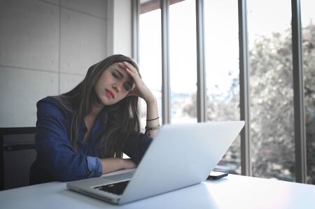 Call Center Service. Photo of customer support or sales agent.  Help line answering and telemarketing. Female caller or receptionist phone operator. Call center staff headaches with the service.の写真素材