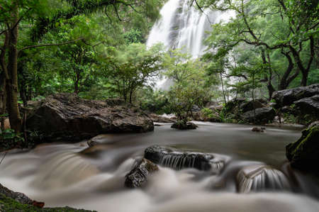 A beautiful waterfall deep in the tropical forest, steep mountain adventure in the rainforest.